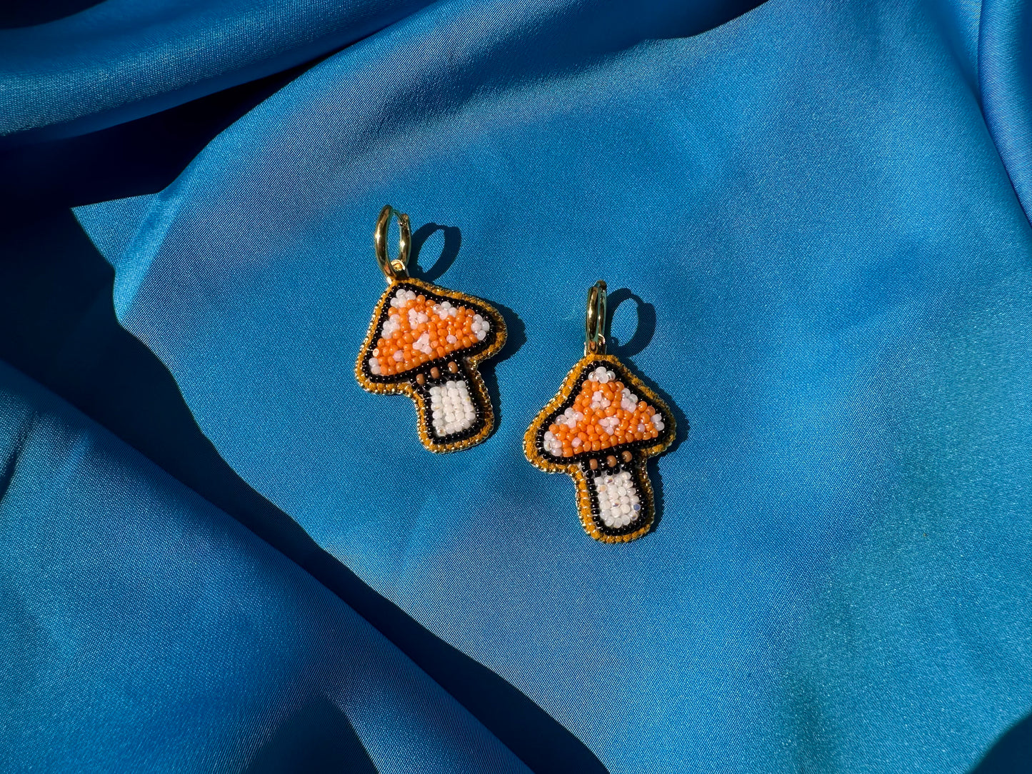 mushroom earrings in orange & white