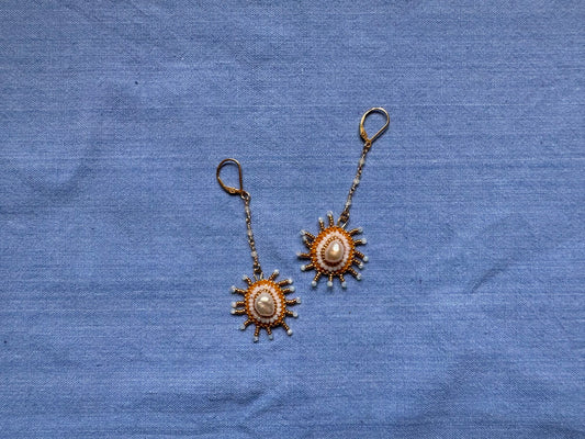 dangling star earrings in opal & gold