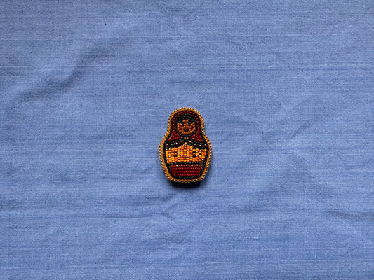 nesting doll pin in crimson & kumquat